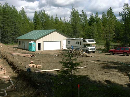 0008 - view of garage, outside plumbing, RV, Jeep and Sue